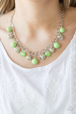 Silver heart charm necklace with light green beads.